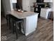 Stylish kitchen features a granite countertop island with seating, stainless steel appliances, and wood-look flooring at 7835 E 296Th St, Atlanta, IN 46031