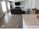 Spacious living room with hardwood floors, gray sofa, fireplace, and large windows for natural light at 7835 E 296Th St, Atlanta, IN 46031