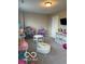 Spacious playroom with a dollhouse, table with chairs and a white beanbag at 7835 E 296Th St, Atlanta, IN 46031
