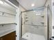 Luxurious bathroom featuring a walk-in shower, accessible bars, and natural stone tile at 851 Pine Lake Dr, Greenwood, IN 46143