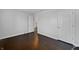 An empty bedroom features an open doorway, dark hardwood flooring, and white trim at 851 Pine Lake Dr, Greenwood, IN 46143