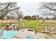 Spacious backyard with a wooden deck, green lawn, and fenced perimeter at 9053 Sunset Ln, Brownsburg, IN 46112