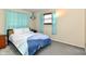 Cozy bedroom with plush carpeting, a comfortable bed, and lots of natural light at 9053 Sunset Ln, Brownsburg, IN 46112