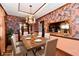 Staged dining room featuring hardwood floors, floral wallpaper, chandelier, table and chairs at 9053 Sunset Ln, Brownsburg, IN 46112