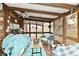 Relaxing sunroom with wicker furniture, ceiling fan, and views of the outdoors at 9053 Sunset Ln, Brownsburg, IN 46112