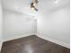 Minimalist bedroom with a ceiling fan, a small window, and hard wood flooring at 917 Buchanan St, Indianapolis, IN 46203