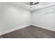 Minimalist bedroom with a ceiling fan, a small window, and hard wood flooring at 917 Buchanan St, Indianapolis, IN 46203