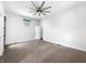 Spacious bedroom featuring a modern ceiling fan, carpeted floors, and bright natural light from a unique window at 917 Buchanan St, Indianapolis, IN 46203