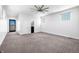 Bright bedroom with carpet, contemporary ceiling fan, and natural light from large windows and glass block window at 917 Buchanan St, Indianapolis, IN 46203