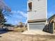 New construction exterior featuring a gray facade, a balcony and an attached two car garage at 917 Buchanan St, Indianapolis, IN 46203