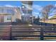 Modern three-story home showcasing multiple balconies, stone accents and a stylish privacy fence at 917 Buchanan St, Indianapolis, IN 46203