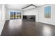Open-concept living room with hardwood floors, modern fireplace, and lots of natural light at 917 Buchanan St, Indianapolis, IN 46203
