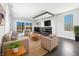 Bright living room features a sleek fireplace, recessed lighting, hardwood floors, and neutral furniture at 917 Buchanan St, Indianapolis, IN 46203