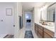 Bathroom showing a vanity with double sinks, a walk-in closet, and laundry decorations at 9184 Anthem Ave, Plainfield, IN 46168