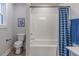 A clean white bathroom with a tub and shower features blue-patterned curtains at 9184 Anthem Ave, Plainfield, IN 46168