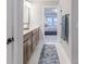 Bathroom featuring double vanity, framed mirror, and an open doorway to a bedroom at 9184 Anthem Ave, Plainfield, IN 46168