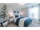 Cozy bedroom featuring a bed with teal bedding and white nightstands with lamps at 9184 Anthem Ave, Plainfield, IN 46168