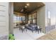 Spacious covered patio offers comfortable seating, a ceiling fan, and views of the backyard at 9184 Anthem Ave, Plainfield, IN 46168
