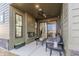 Inviting covered patio with an outdoor fireplace and comfortable seating area at 9184 Anthem Ave, Plainfield, IN 46168