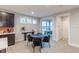 Bright dining area features a modern table, stylish chairs, and sliding glass doors to the patio at 9184 Anthem Ave, Plainfield, IN 46168