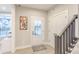 Front entryway with wood-look floors, a rug, stairs and access to the outside at 9184 Anthem Ave, Plainfield, IN 46168