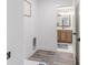Laundry room with vinyl flooring, laundry instructions artwork, and access to a bathroom at 9184 Anthem Ave, Plainfield, IN 46168