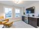 The sitting room in this primary suite offers a wet bar, bright natural light and comfortable seating at 9184 Anthem Ave, Plainfield, IN 46168