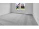 Bright bedroom featuring plush carpet and large windows overlooking neighborhood at 9198 Anthem Ave, Plainfield, IN 46168