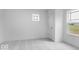 This bedroom features plush carpet, a window, neutral walls, and a closet door at 9198 Anthem Ave, Plainfield, IN 46168