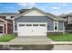 Charming home featuring a two-car garage, blue siding, and a well-manicured lawn at 9198 Anthem Ave, Plainfield, IN 46168