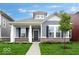 Charming single-Gathering home with gray siding, brick accents, black shutters, and a well-manicured front yard at 9198 Anthem Ave, Plainfield, IN 46168