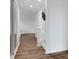 This hallway features wood floors, white walls, and a staircase at 9198 Anthem Ave, Plainfield, IN 46168