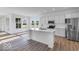 Bright kitchen with a large island, stainless steel appliances, and white cabinetry at 9198 Anthem Ave, Plainfield, IN 46168