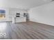 Open concept kitchen with stainless steel appliances, white cabinets, and wood-look floors at 9198 Anthem Ave, Plainfield, IN 46168
