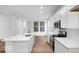 Contemporary kitchen with white cabinets, stainless steel appliances, and hardwood floors at 9198 Anthem Ave, Plainfield, IN 46168
