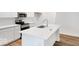 Bright kitchen featuring white cabinets, stainless steel appliances, an island with sink, and hardwood floors at 9198 Anthem Ave, Plainfield, IN 46168