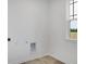 This laundry room features tile floors, neutral walls, hookups, and a window at 9198 Anthem Ave, Plainfield, IN 46168