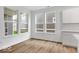 Bright living room features hardwood floors, large windows with neighborhood views, and neutral walls and trim at 9198 Anthem Ave, Plainfield, IN 46168