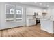 Bright open-concept living and kitchen area with hardwood floors, neutral walls and trim, stainless appliances at 9198 Anthem Ave, Plainfield, IN 46168
