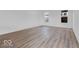 Spacious living room showcasing wood-look floors and large windows for natural light at 9198 Anthem Ave, Plainfield, IN 46168