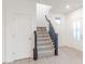 Bright foyer featuring a carpeted staircase with a dark wood railing, and a white door on the left at 9210 Anthem Ave, Plainfield, IN 46168