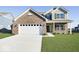 Charming two-story home with brick accents, a two-car garage, and a well-manicured lawn at 943 Rushmore Dr, Pittsboro, IN 46167