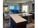 Open concept kitchen with stainless steel appliances, a breakfast bar, and views of the living area at 943 Rushmore Dr, Pittsboro, IN 46167