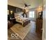 Serene main bedroom with a wooden bed frame, accent wall, and soft natural light at 943 Rushmore Dr, Pittsboro, IN 46167