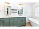 Beautiful bathroom with double vanity, shaker cabinets, freestanding tub, and modern lighting at 10580 Saddlestone Dr, Fishers, IN 46040