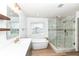 Modern bathroom with double vanity, freestanding tub, and glass-enclosed shower at 10580 Saddlestone Dr, Fishers, IN 46040