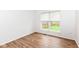 Bedroom with wood look flooring and a view of the yard from a window with blinds at 10580 Saddlestone Dr, Fishers, IN 46040