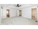 Spacious bedroom with tray ceiling, carpet, and multiple doorways, plus an en-suite bathroom at 10580 Saddlestone Dr, Fishers, IN 46040