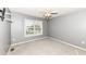 Neutral bedroom features a ceiling fan and a window with natural light at 10580 Saddlestone Dr, Fishers, IN 46040