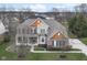 Stunning two-story home boasts brick, stone, and cedar accents, plus a perfectly manicured front yard at 10580 Saddlestone Dr, Fishers, IN 46040